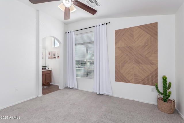 spare room with lofted ceiling, light colored carpet, and ceiling fan