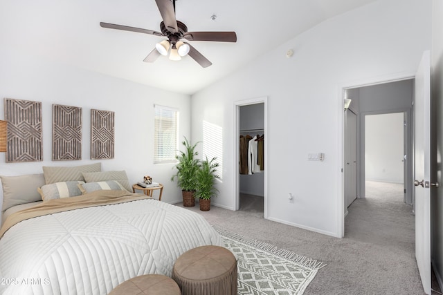 carpeted bedroom featuring lofted ceiling, ceiling fan, a spacious closet, and a closet