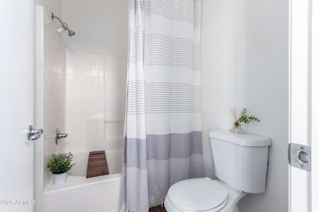 bathroom featuring shower / bath combination with curtain and toilet