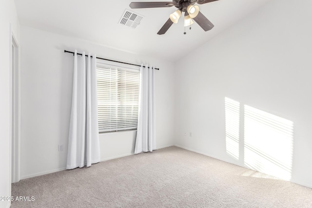 carpeted spare room with ceiling fan and vaulted ceiling