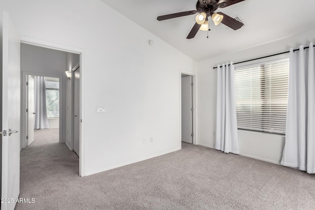 unfurnished bedroom with ceiling fan, vaulted ceiling, and light colored carpet