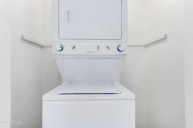 clothes washing area featuring stacked washer / dryer