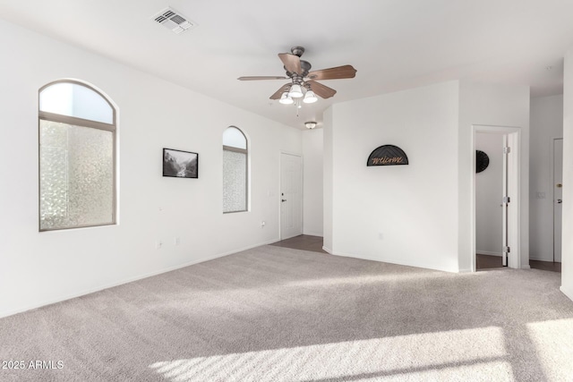 carpeted empty room featuring ceiling fan