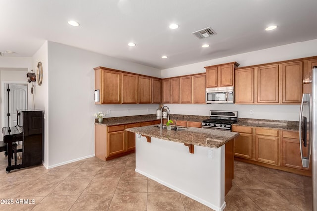 4495 E Woodside Way, Gilbert, AZ 85297 - kitchen with brown cabinetry, stainless steel appliances, visible vents, and a sink