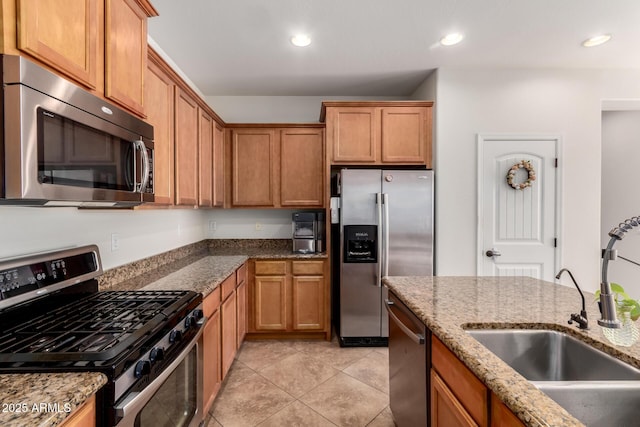 4495 E Woodside Way, Gilbert, AZ 85297 - kitchen featuring brown cabinets, stone countertops, appliances with stainless steel finishes, and a sink