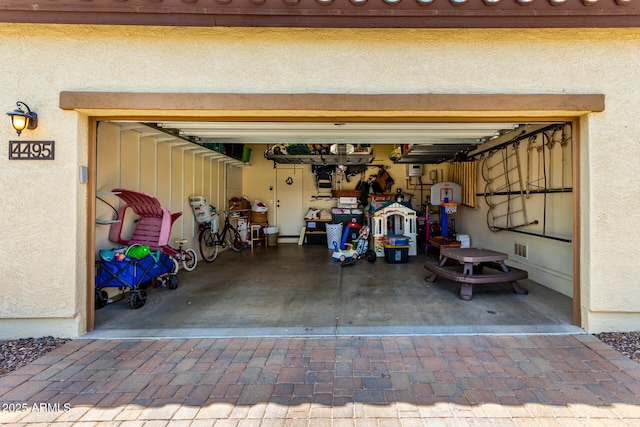 4495 E Woodside Way, Gilbert, AZ 85297 - garage featuring decorative driveway and visible vents