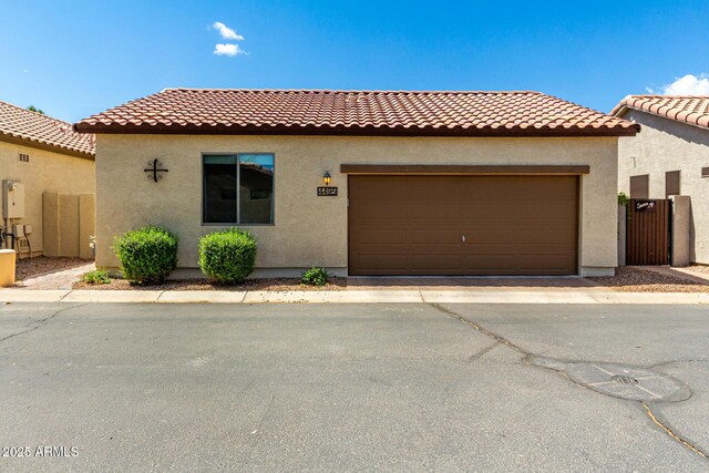 4495 E Woodside Way, Gilbert, AZ 85297 - mediterranean / spanish house featuring an attached garage, a tile roof, and stucco siding