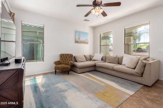4495 E Woodside Way, Gilbert, AZ 85297 - living room with visible vents, baseboards, ceiling fan, and light tile patterned floors