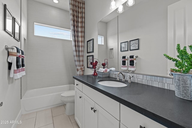 bathroom with tile patterned floors, shower / bath combo with shower curtain, toilet, and vanity