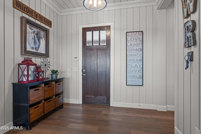 entrance foyer featuring baseboards, ornamental molding, and dark wood-style flooring