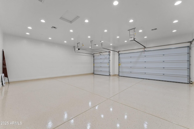 garage with recessed lighting, visible vents, baseboards, and a garage door opener