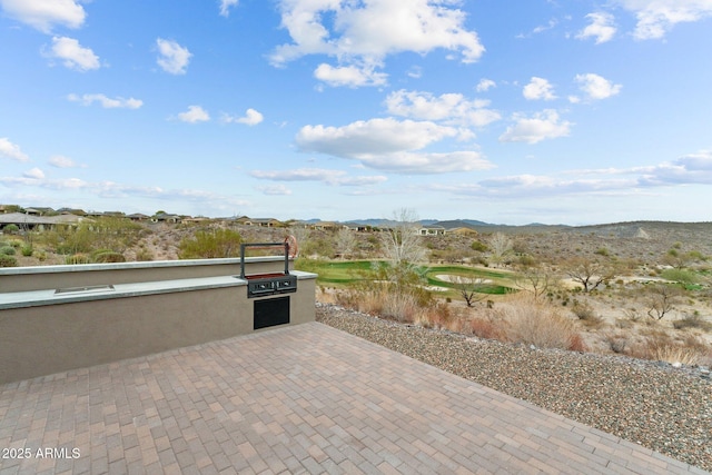 view of patio featuring area for grilling and a mountain view