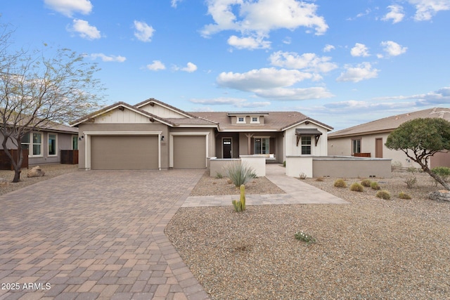 view of front of property with decorative driveway, a garage, and stucco siding