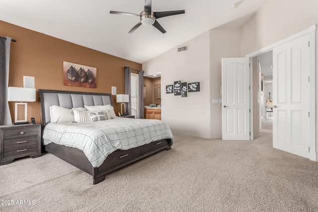 bedroom with visible vents, ceiling fan, carpet, vaulted ceiling, and ensuite bath