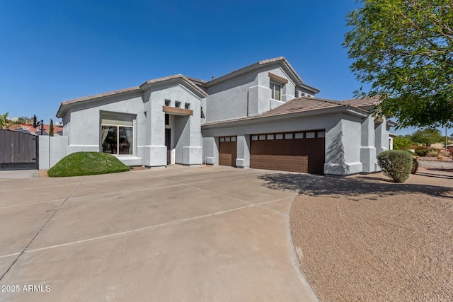 view of front of home with stucco siding, driveway, and a tiled roof