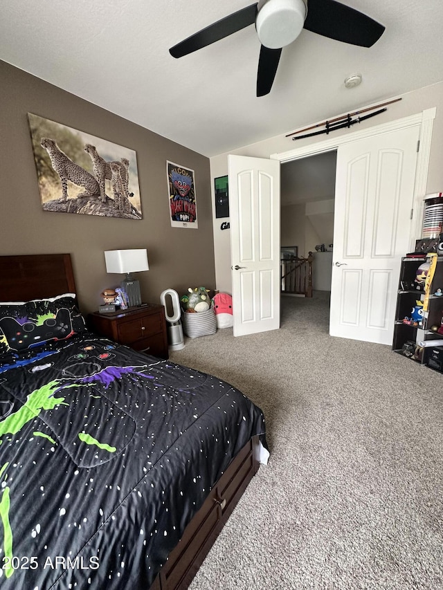 carpeted bedroom with a ceiling fan