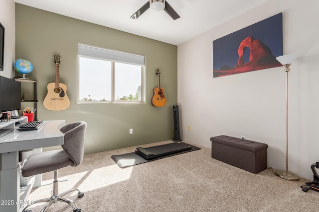 home office with carpet and a ceiling fan