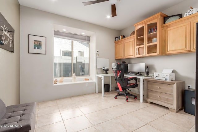 home office featuring light tile patterned floors, built in desk, and ceiling fan