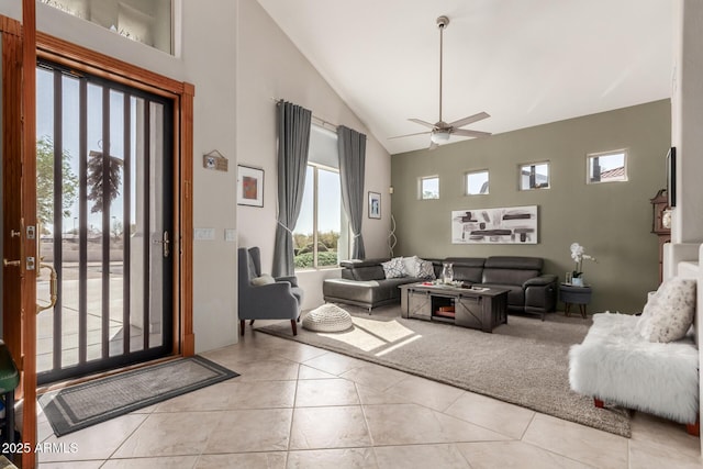 living room with high vaulted ceiling, ceiling fan, and light tile patterned flooring