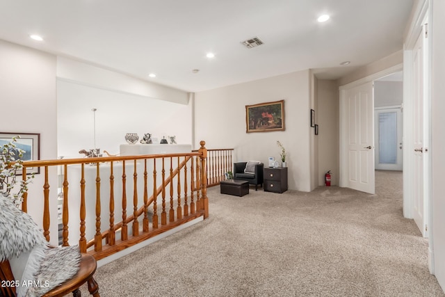 hallway with carpet, recessed lighting, an upstairs landing, and visible vents