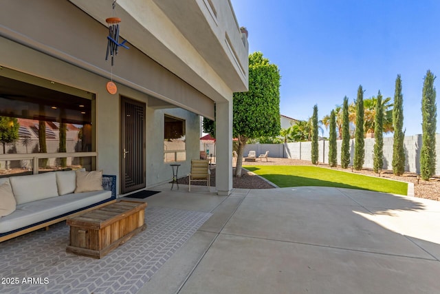 view of patio / terrace featuring an outdoor living space and fence