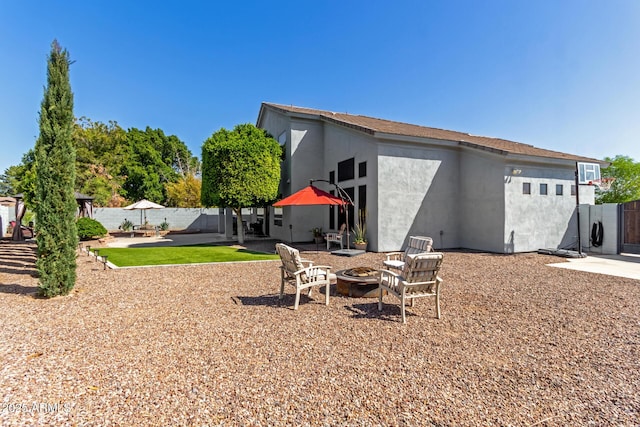 view of yard with a patio area, a fire pit, and fence