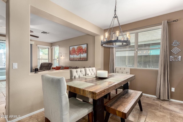 dining area featuring a notable chandelier