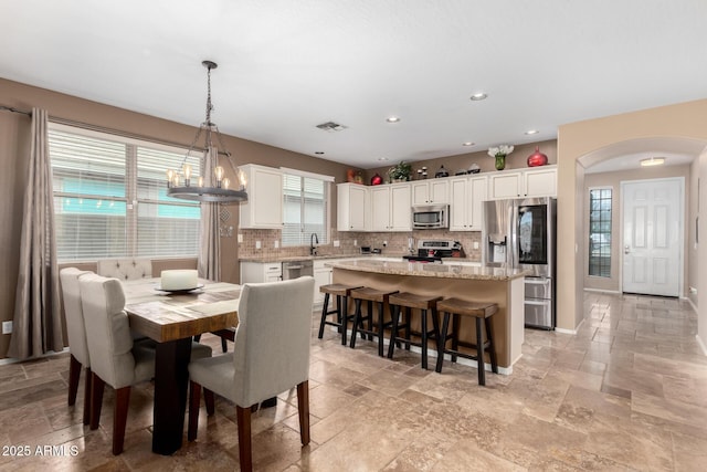 dining space featuring a notable chandelier and a wealth of natural light