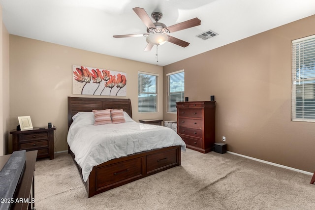 bedroom with ceiling fan and light colored carpet