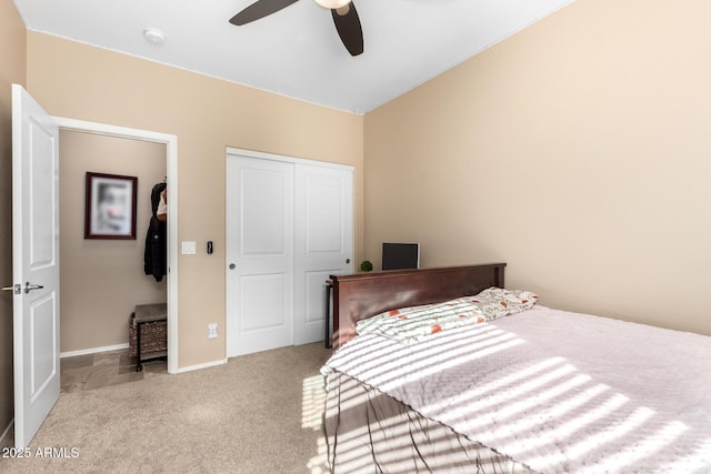 carpeted bedroom with ceiling fan and a closet