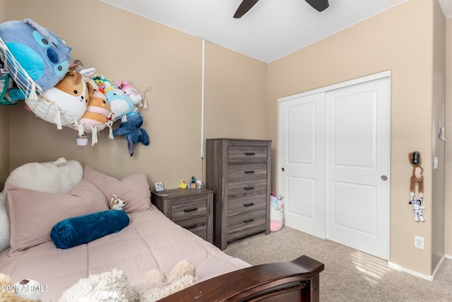 carpeted bedroom with ceiling fan and a closet