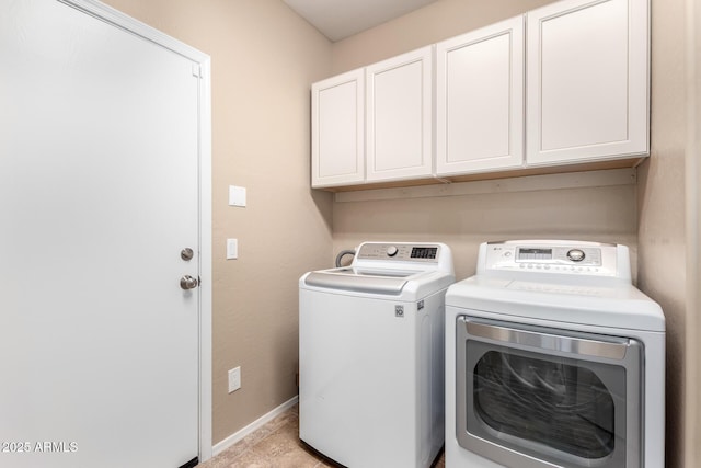 clothes washing area featuring cabinets and independent washer and dryer