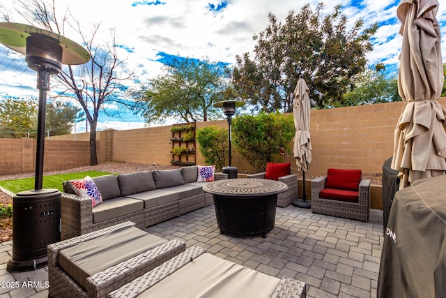 view of patio featuring an outdoor living space with a fire pit