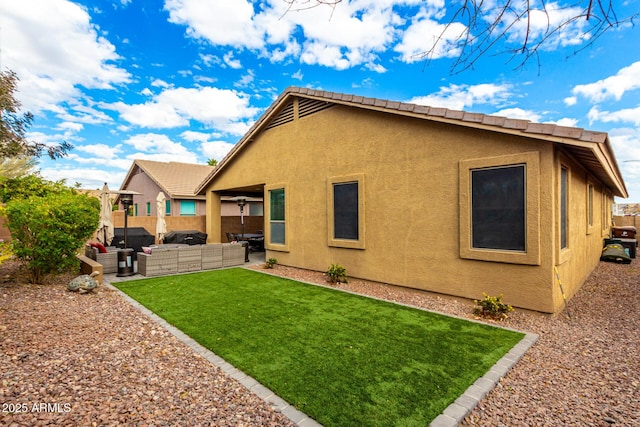 back of house featuring a patio area, an outdoor living space, and a lawn