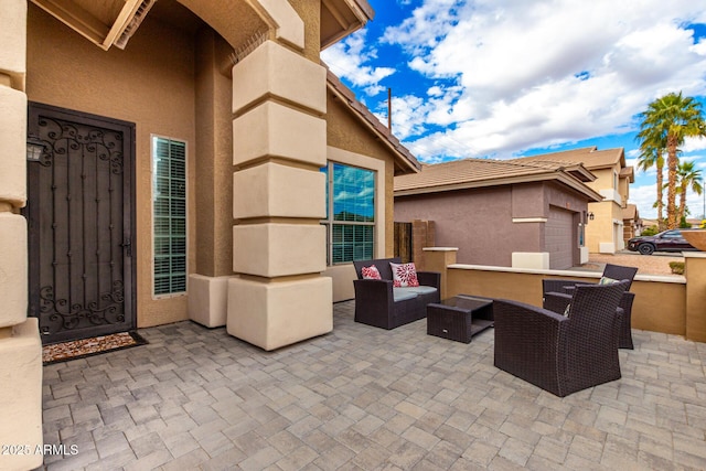 view of patio featuring an outdoor living space and a garage