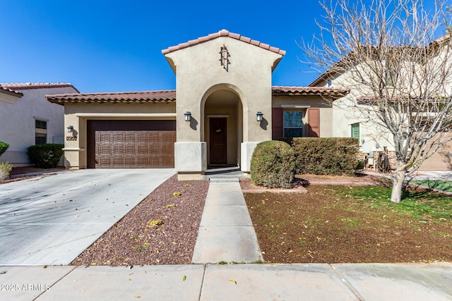 20496 W Valley View Dr, Buckeye, AZ 85396 - mediterranean / spanish-style house with stucco siding, a garage, a tile roof, and driveway