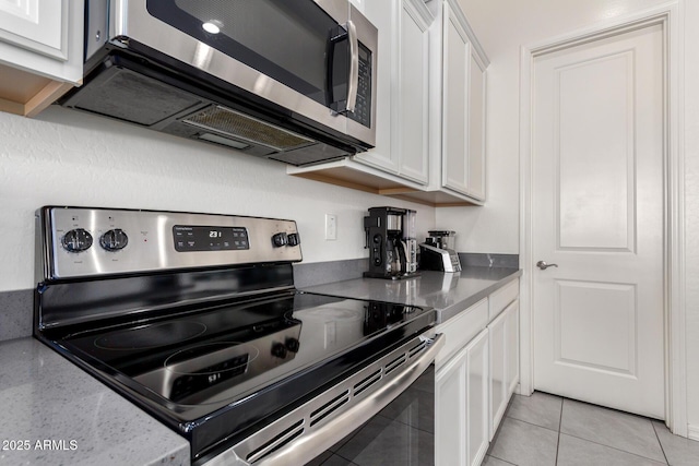 20496 W Valley View Dr, Buckeye, AZ 85396 - kitchen featuring stainless steel appliances, white cabinetry, stone countertops, and light tile patterned floors