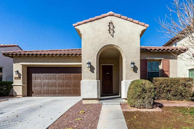 20496 W Valley View Dr, Buckeye, AZ 85396 - mediterranean / spanish house with an attached garage, concrete driveway, stucco siding, and a tiled roof