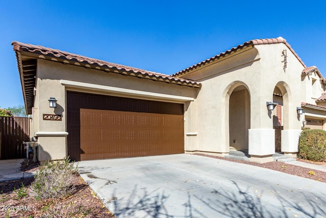 20496 W Valley View Dr, Buckeye, AZ 85396 - mediterranean / spanish house featuring stucco siding, concrete driveway, an attached garage, and a tiled roof