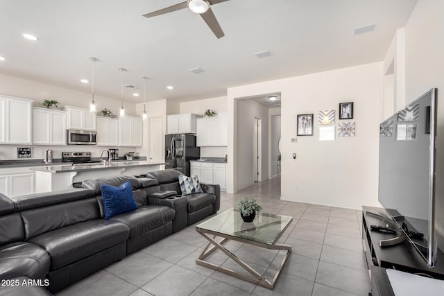 20496 W Valley View Dr, Buckeye, AZ 85396 - living room featuring a ceiling fan, recessed lighting, light tile patterned floors, and baseboards