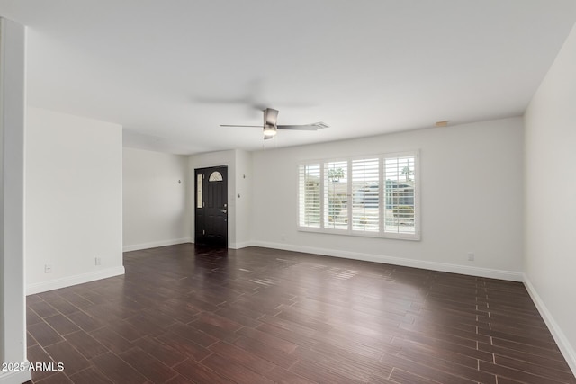 empty room featuring dark wood-type flooring and ceiling fan