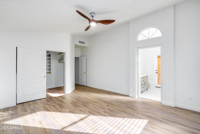 unfurnished bedroom with visible vents, light wood-style flooring, and baseboards