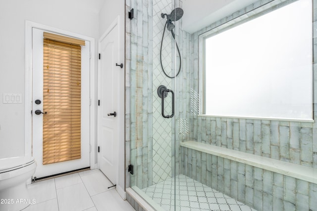 full bathroom with tile patterned flooring, a shower stall, and toilet