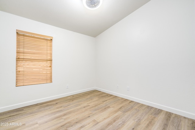 unfurnished room with baseboards and wood finished floors