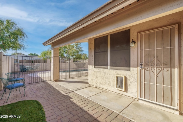 view of patio featuring fence