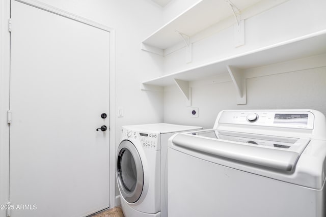 laundry room featuring washing machine and clothes dryer and laundry area