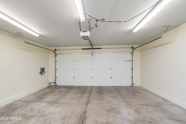 garage with a garage door opener and baseboards