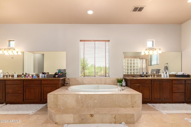 bathroom featuring vanity and independent shower and bath