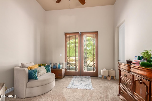 sitting room with french doors, ceiling fan, and carpet