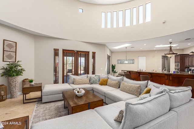 tiled living room with a towering ceiling